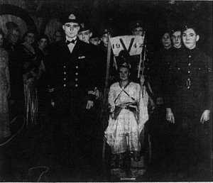 Miss Joan Jeffries dressed at Britannia surrounded by servicemen