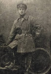 Portrait of soldier Sidney V. Langton of the Royal Field Artillery leaning against motorbike