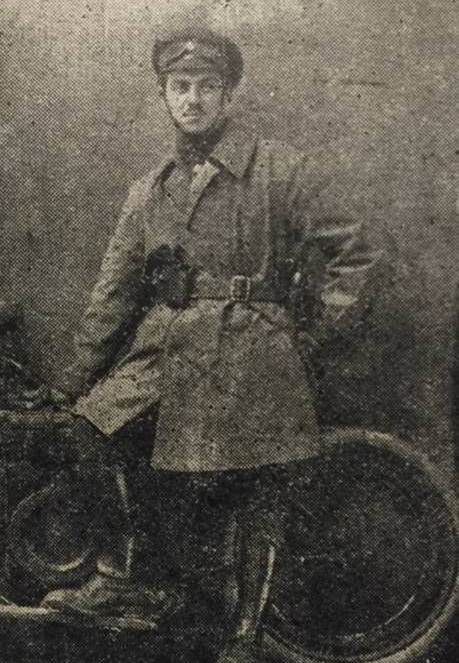 Portrait of soldier Sidney V. Langton of the Royal Field Artillery leaning against motorbike